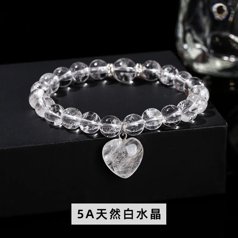 Handmade women's bracelet with natural gemstone beads and a silver love pendant charm.