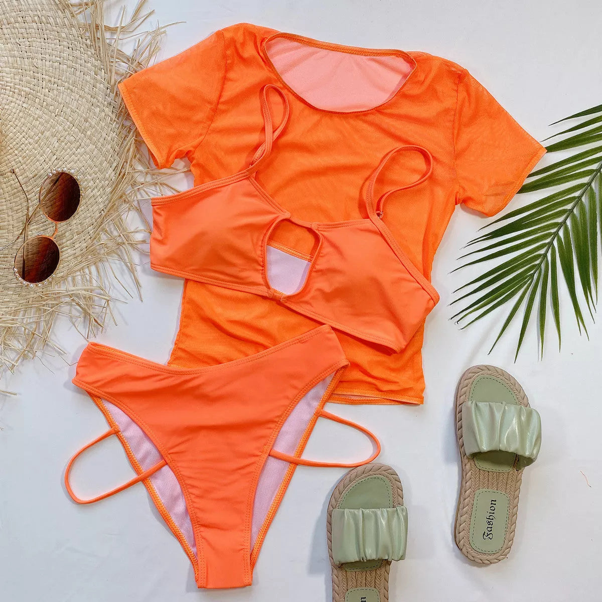 Orange high-waist ladies bikini three-piece set on a beach backdrop