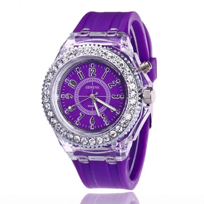 Women's LED luminous quartz watch with silicone strap and round alloy case on wrist