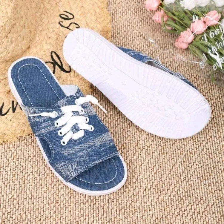 Blue Roman-style women's flat canvas slippers with a cloth upper and rubber sole.