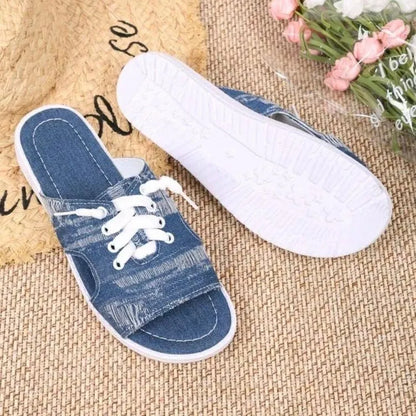 Blue Roman-style women's flat canvas slippers with a cloth upper and rubber sole.