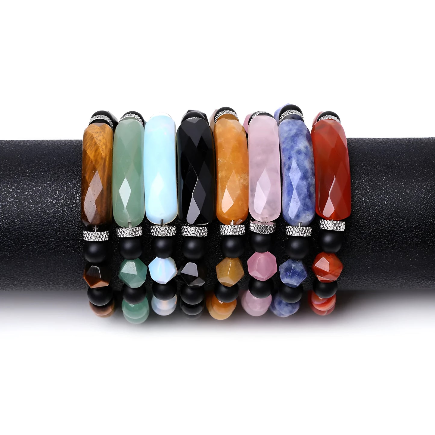 Handmade diamond-shaped cut black agate bracelet with fan-shaped details on a wrist.