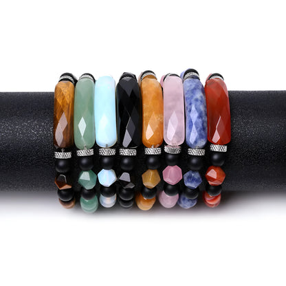 Handmade diamond-shaped cut black agate bracelet with fan-shaped details on a wrist.
