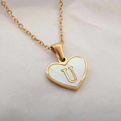 Gold-plated clavicle necklace with a white shell heart pendant, personalised with a letter from A to Z.