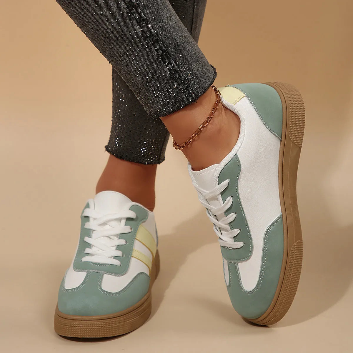 Green women's low-top retro sports shoes with cross-strap design and round toe.