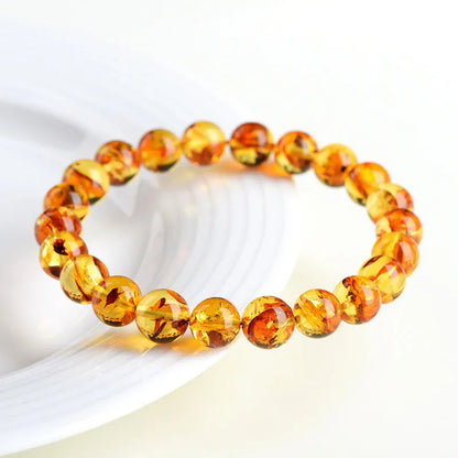 Natural yellow piebald amber bracelet with 7-10mm geometric beads on wrist
