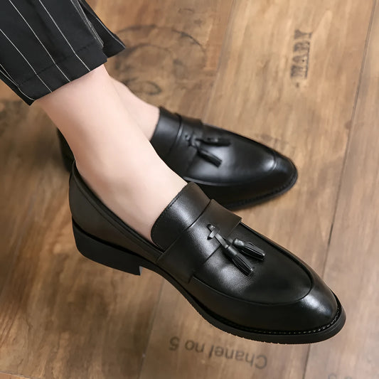 Men's black and brown business casual slip-on shoes with tassel detail and pointed toe