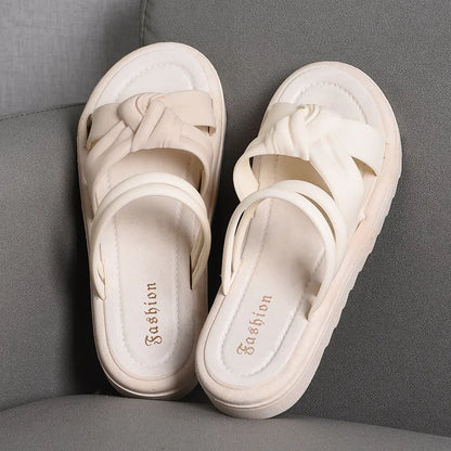 Women's black PVC sandals with thick soft back, floral detail, and injection moulded sole