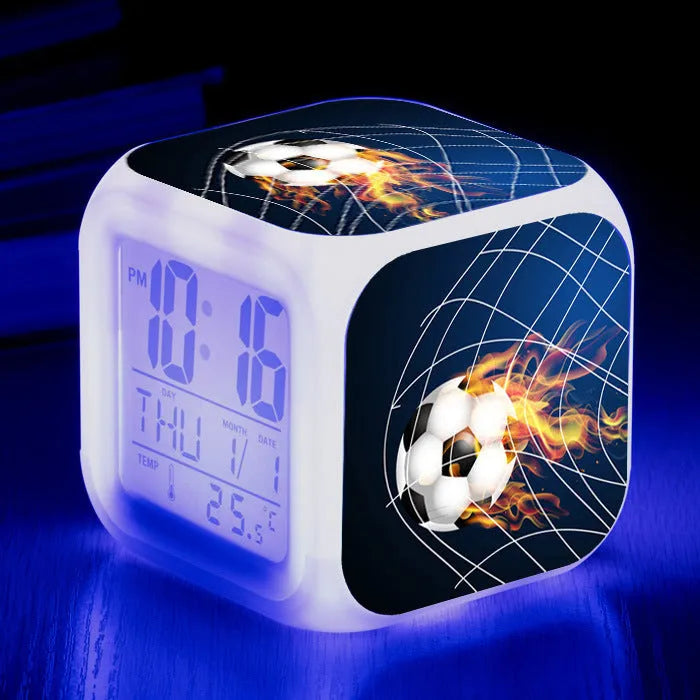 Colourful cartoon football pattern children's mute alarm clock on a table.