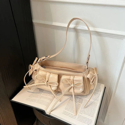Women's tassel bow shoulder bag in pleated design with multiple pockets, shown in a selected colour.