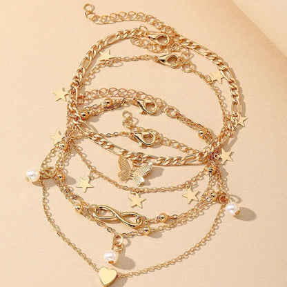 Four-piece women's anklet set with butterfly, pearl, and heart designs in alloy metal