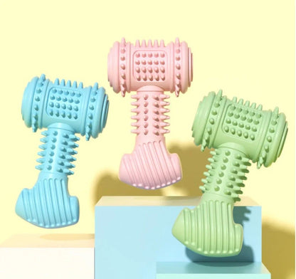 Indestructible TPR dog chew toy in blue, pink, and green for teeth cleaning and anxiety relief