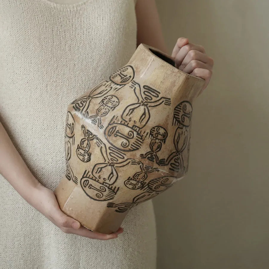Hand-painted ceramic vase with religious patterns and carved texture in cylindrical shape