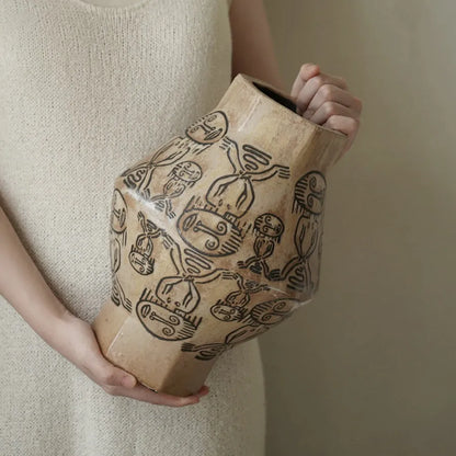 Hand-painted ceramic vase with religious patterns and carved texture in cylindrical shape