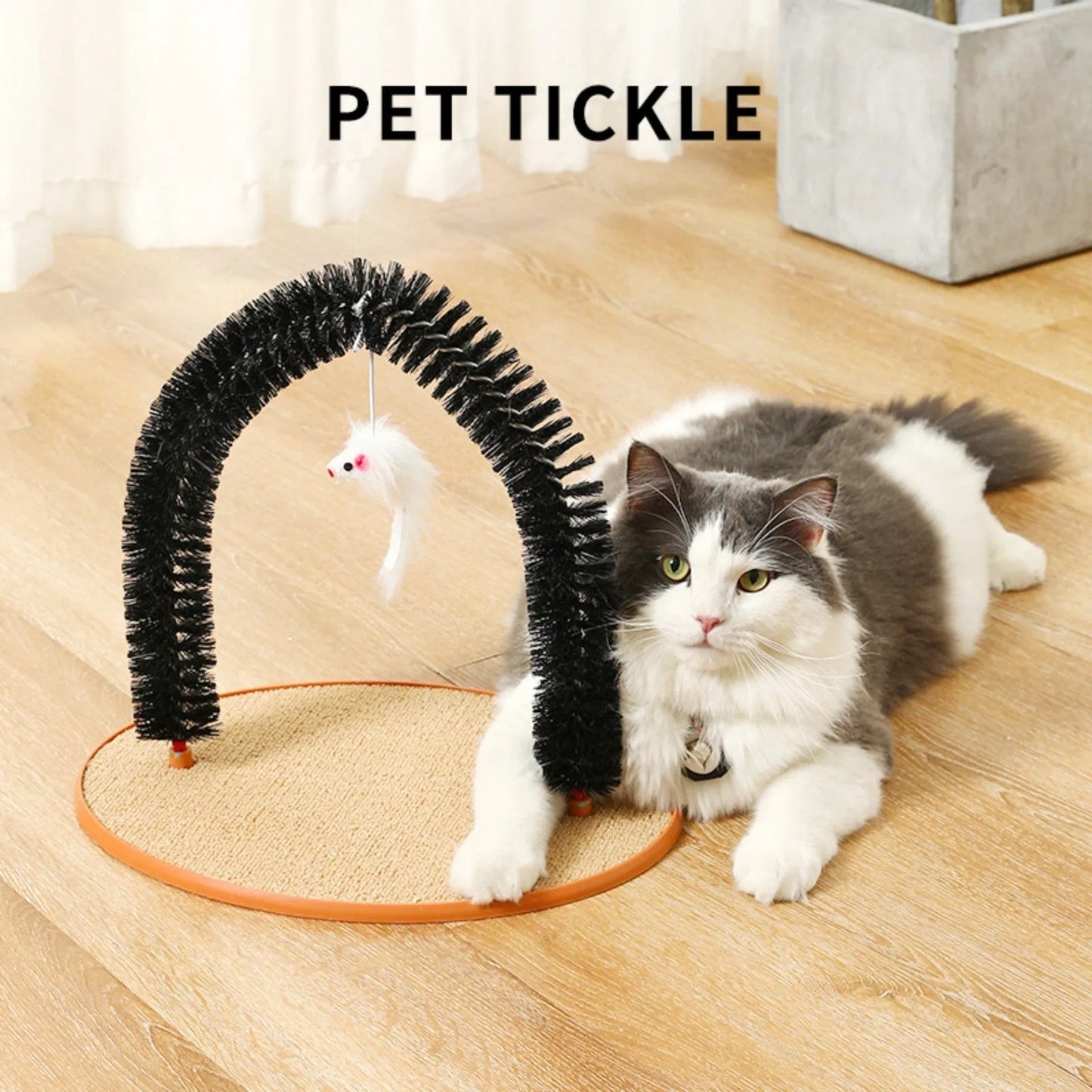 Black arch-shaped cat grooming brush with scratching fibre and an attached mouse toy on a non-slip base