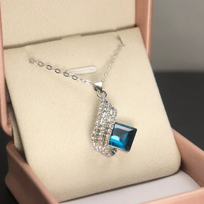 Women's alloy pendant and glass necklace with matching electroplated ear studs in cross chain style.
