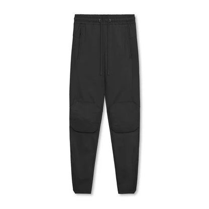 Men's grey fitness trousers with ankle ties, made from quick-drying polyester, for exercise and casual use.