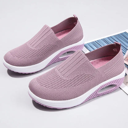 Women's beige mesh running shoes with round toe and air cushion midsole on a grey background.