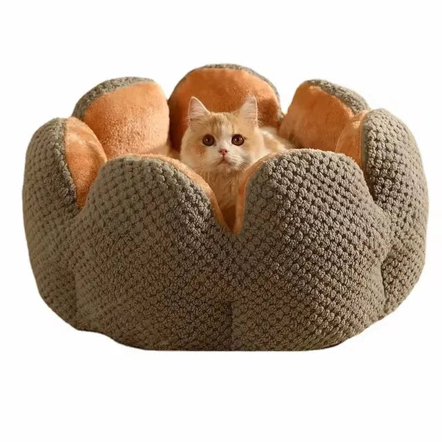 Green cactus petal shape pet bed for cats and dogs on a hardwood floor.