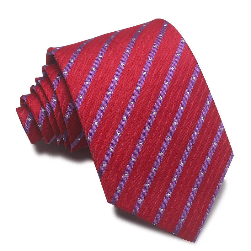 Close-up of a red and black striped jacquard weave tie with an arrow tip, showing texture.