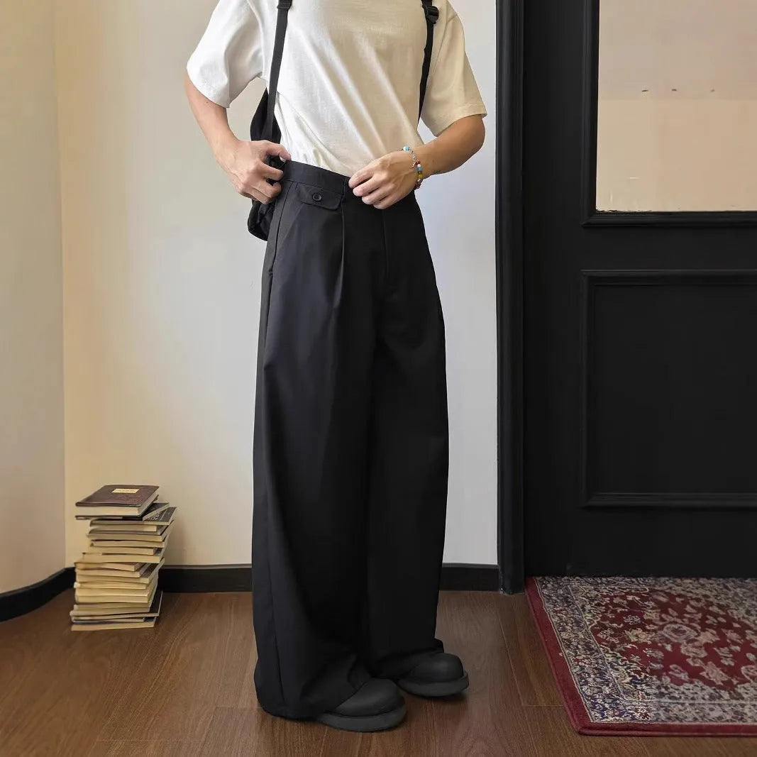 Men's straight-leg wide-fit casual trousers in brown, showing loose drape and straight cut from knee to ankle.