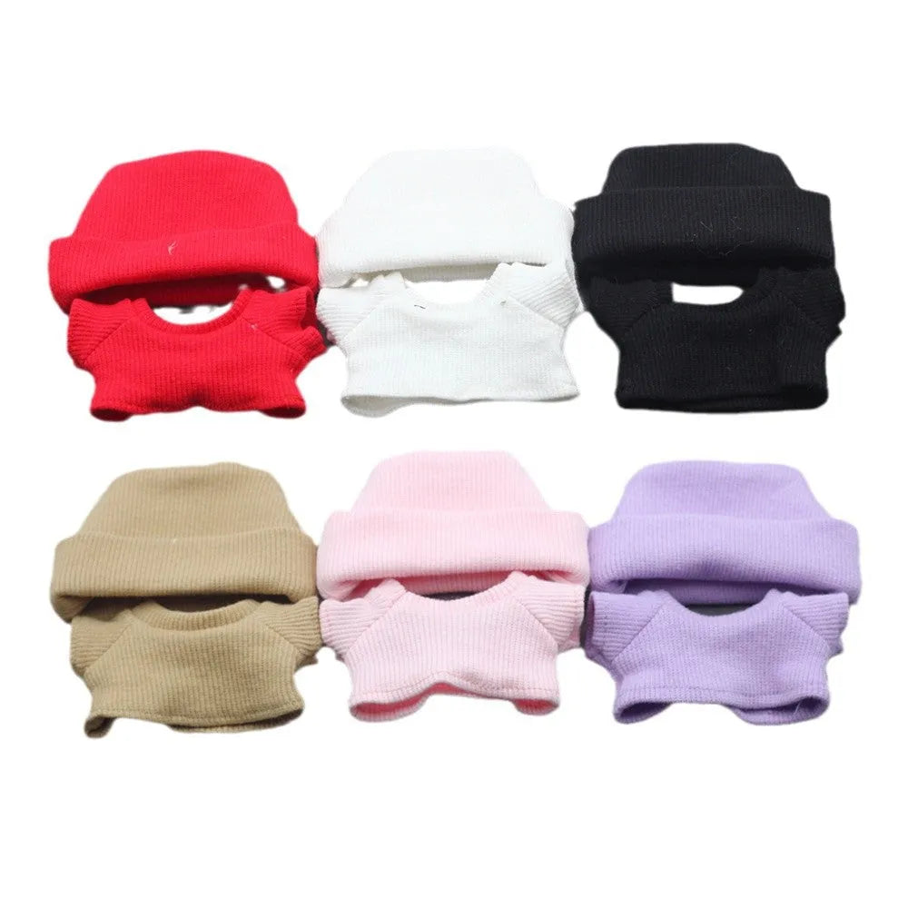Doll clothes set with knitted flanging hat and T-shirt in multiple colours including pink, white, and stripes.