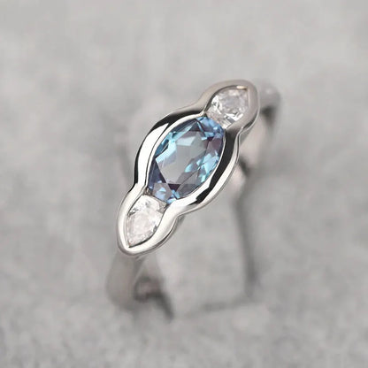 Women's geometric ellipse copper ring with inlaid zircon in white gold colour, showing distinctive non-circular shape