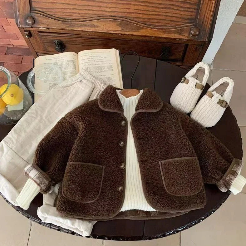 Children's beige one-piece velvet jacket with single-breasted closure showing polyester lining