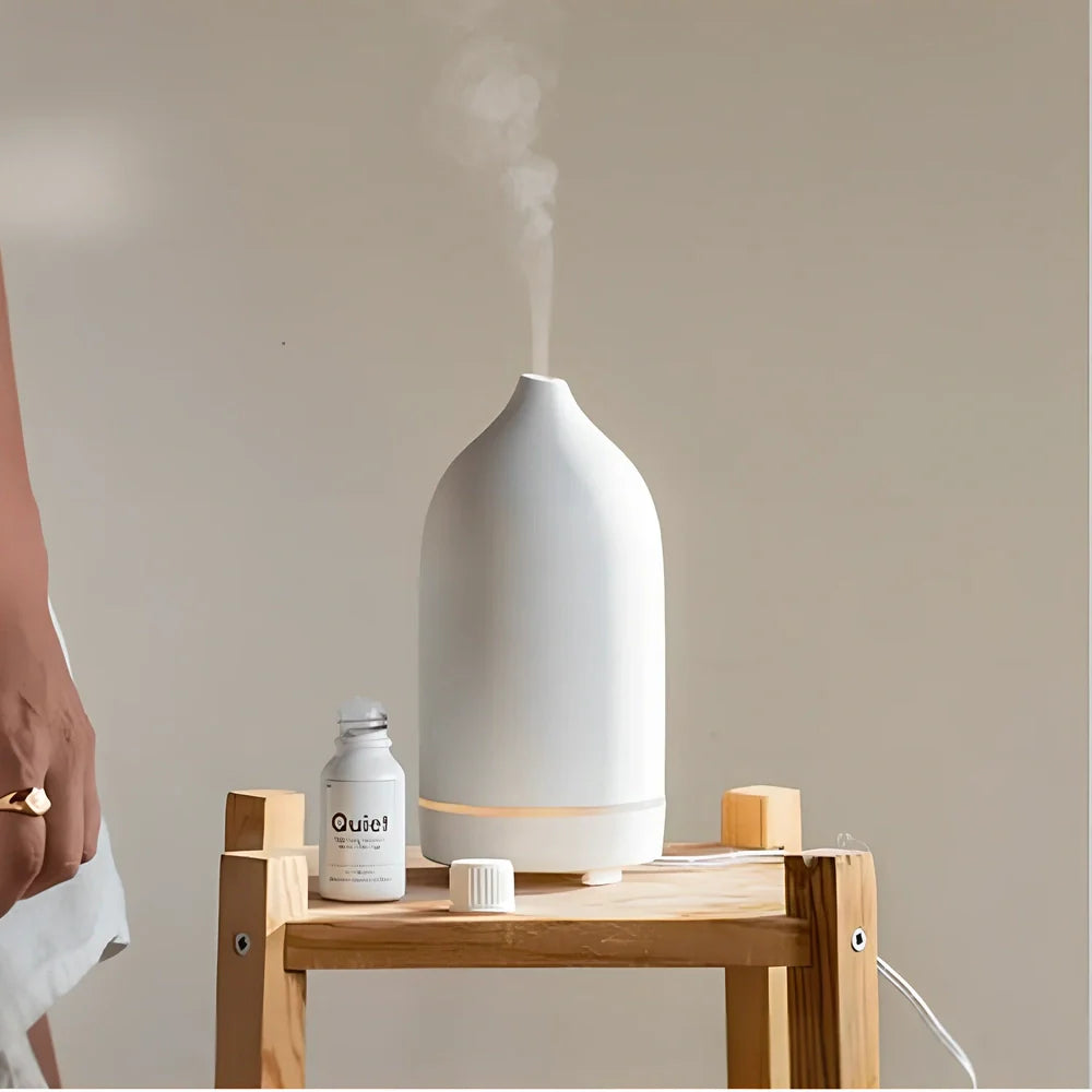 Ceramic ultrasonic aroma diffuser in white with 100ml tank, diffusing mist in home setting, 10cm diameter