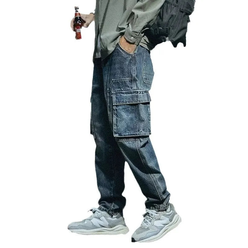Men's blue loose straight leg jeans with a zip fly, shown on a model.