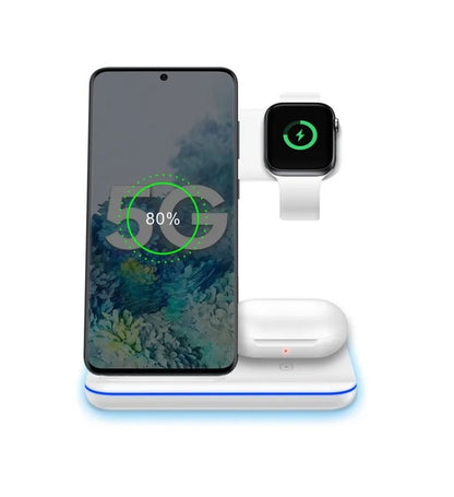 White three-in-one wireless charging stand for mobile phone, watch, and headphones on a desk.