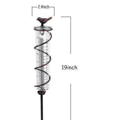 Cast iron hummingbird-shaped rain gauge with glass measurement tube showing 1-20 scale markings