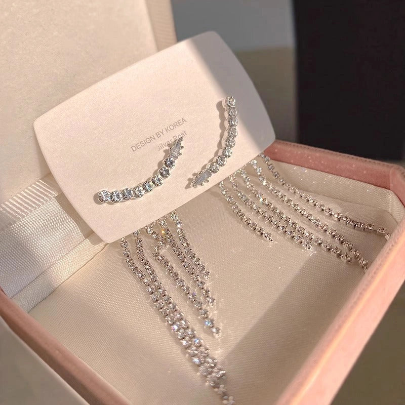 Sparkling zircon tassel earrings in sterling silver, featuring dazzling gems and flowing tassels for a bold, fashionable look.