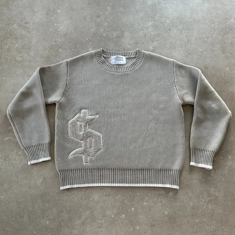 Grey loose-fitting jacquard knit coat with long sleeves on a hanger