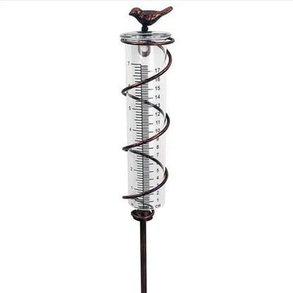 Cast iron hummingbird-shaped rain gauge with glass measurement tube showing 1-20 scale markings