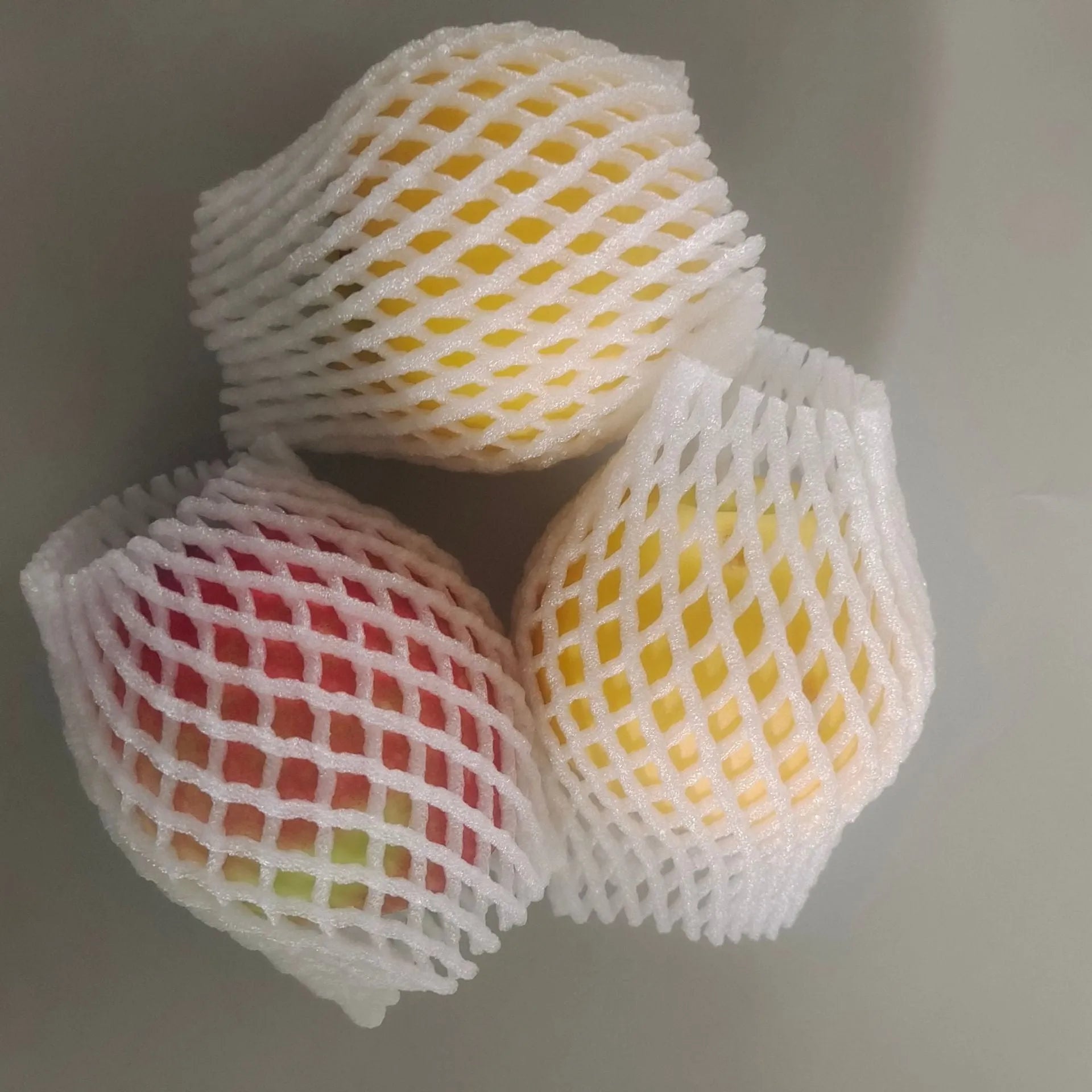 A white foam protective net sleeve stretched open, showing its simple tubular construction.