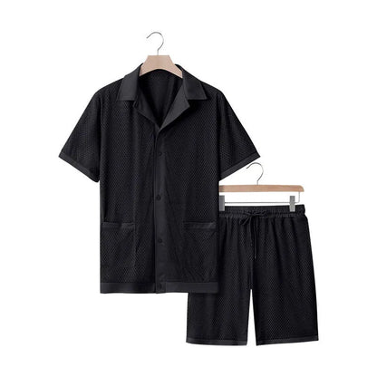Women's lake blue see-through short sleeve cardigan and matching shorts beach cover-up set laid flat.