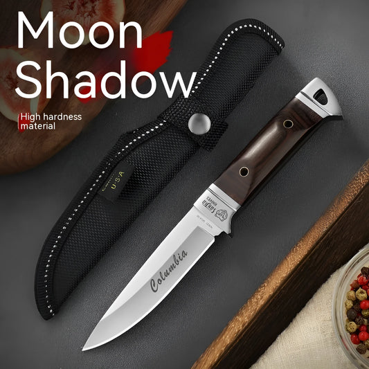 Camping fruit knife with stainless steel blade and brown leather sheath on a wooden surface