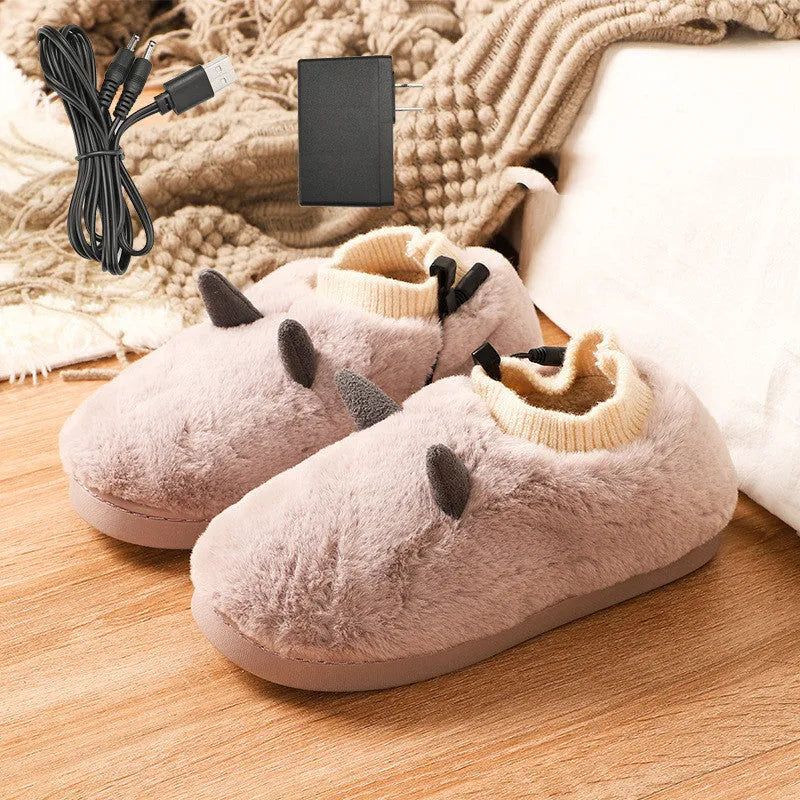 USB-powered electric slippers in black with a connected USB cable, showing soft velvet upper and plastic sole.