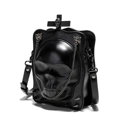 Black mini square messenger bag with embossed skull design, metal chains, and crossbody strap