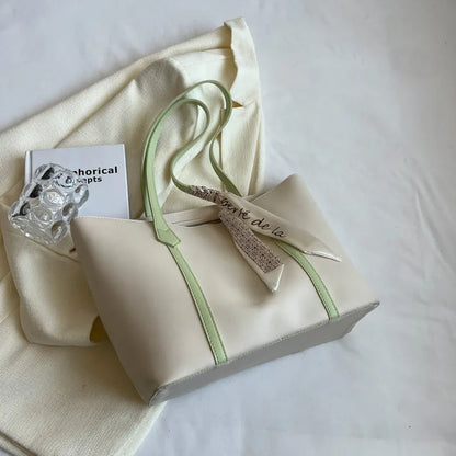 Soft large-capacity bucket tote bag with shoulder strap and zip pocket, shown in a neutral colour.