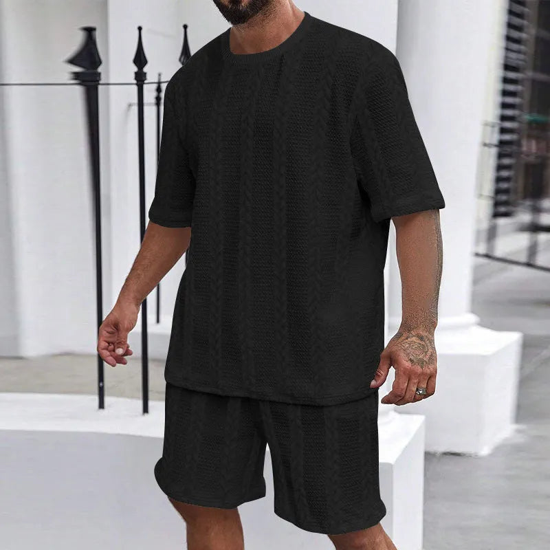 Knitted short-sleeve pullover and matching shorts set in light grey, laid flat.