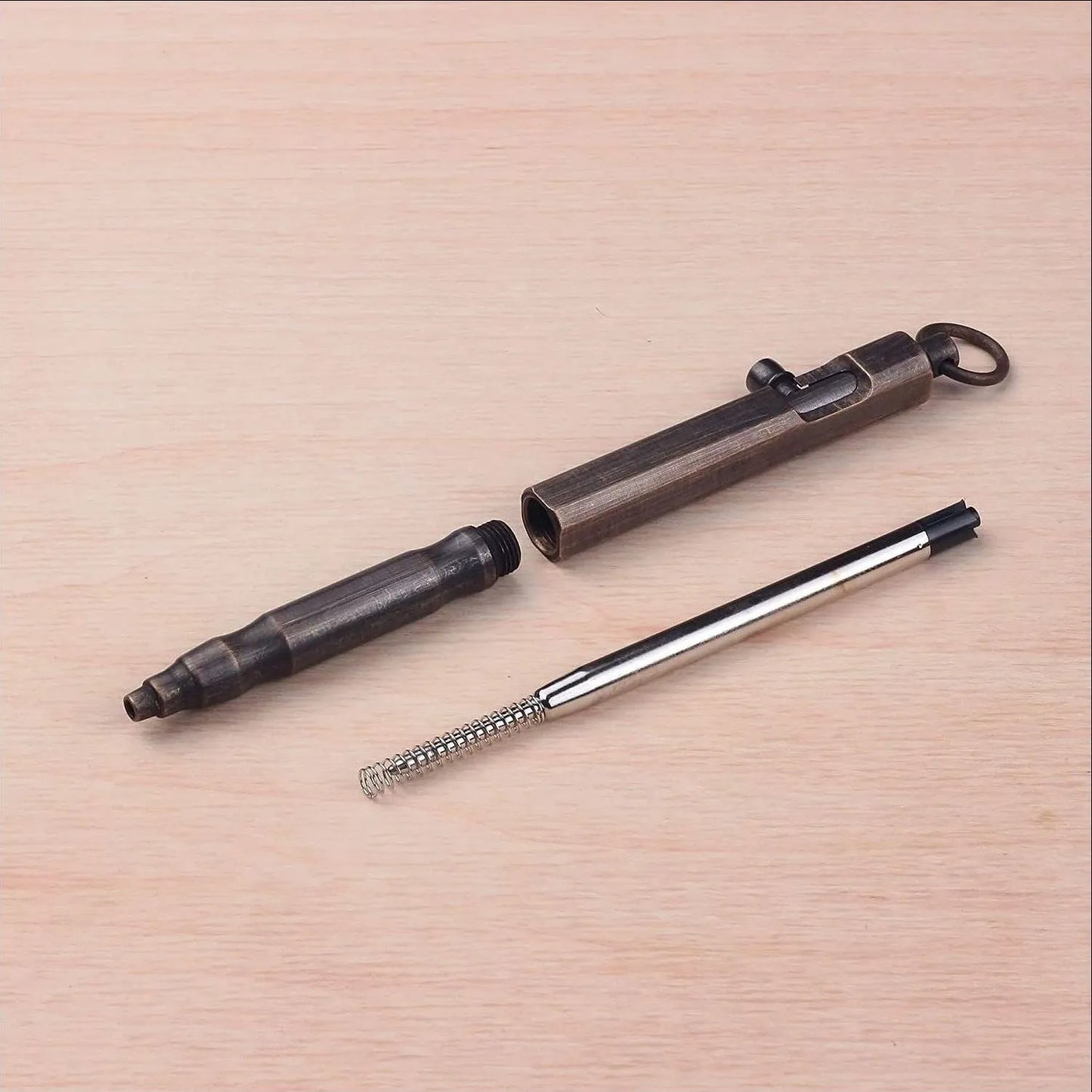 Brass tactical pen with hexagonal bolt design showing natural brass colour option