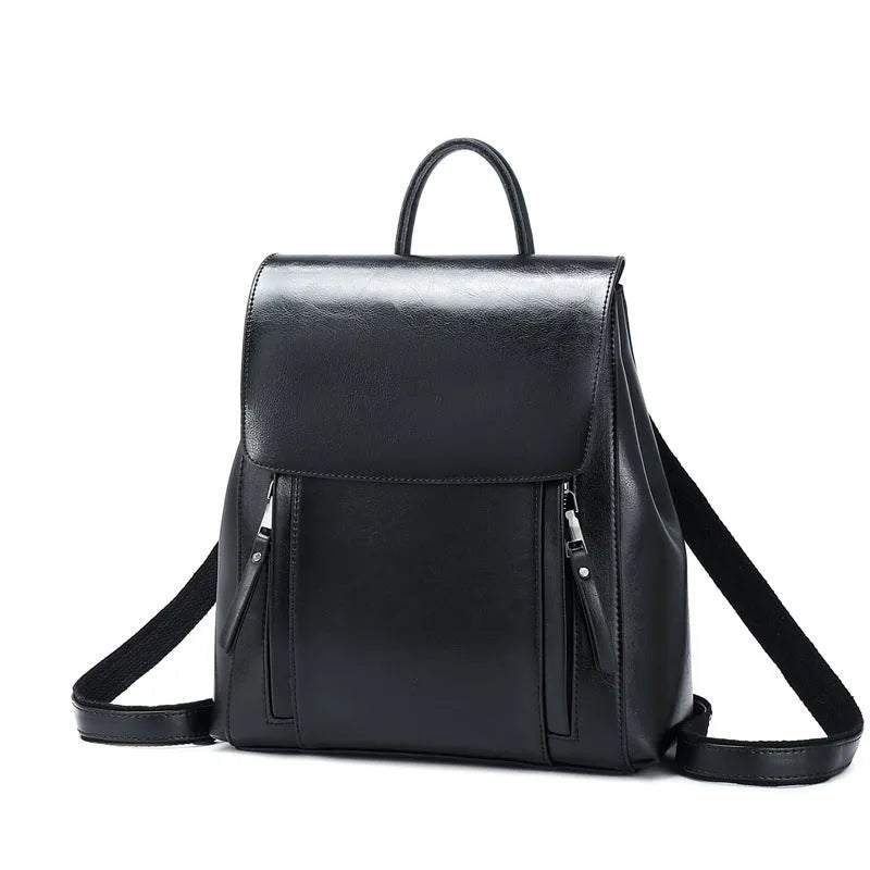Genuine leather women's backpack with multiple compartments showing stitching details and cover-type opening