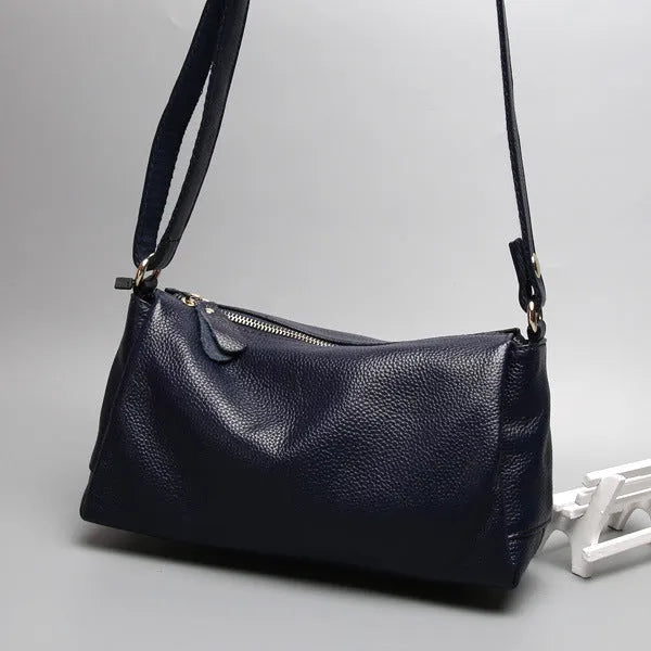 Soft genuine leather women's crossbody bag in horizontal square shape with single shoulder strap.