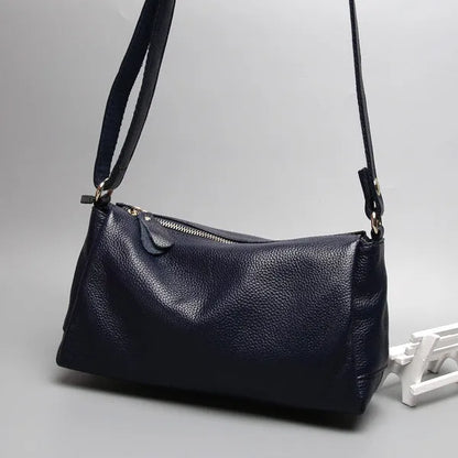 Soft genuine leather women's crossbody bag in horizontal square shape with single shoulder strap.