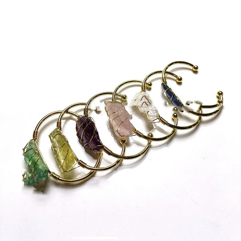 Unshaped natural crystal rough stone bracelet with gold winding metal accents in geometric design