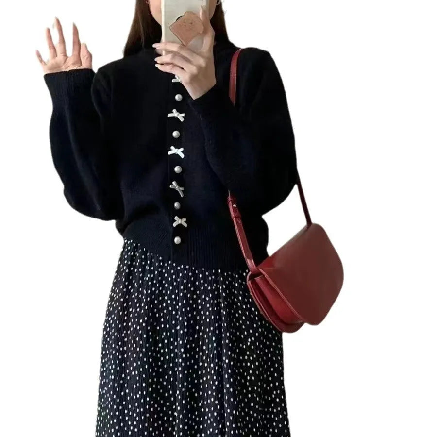 Women's solid colour cardigan sweater with bow pattern and pearl buttons in light blue.