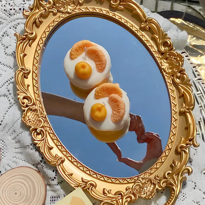 Handmade orange soy wax candle with 5cm diameter and 6cm height in cylindrical shape