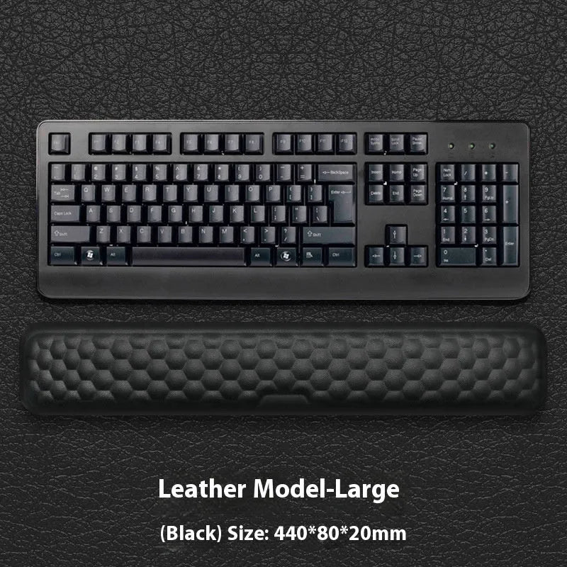 Black and grey memory foam mouse wrist rests with cloth and leather-style covers on a desk.
